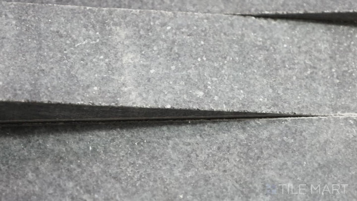 Video featuring Rockmount Cosmic Black 6X24 Stacked Stone Panel Honed Marble. A sophisticated black marble panel with a honed finish, ideal for high-end interiors.