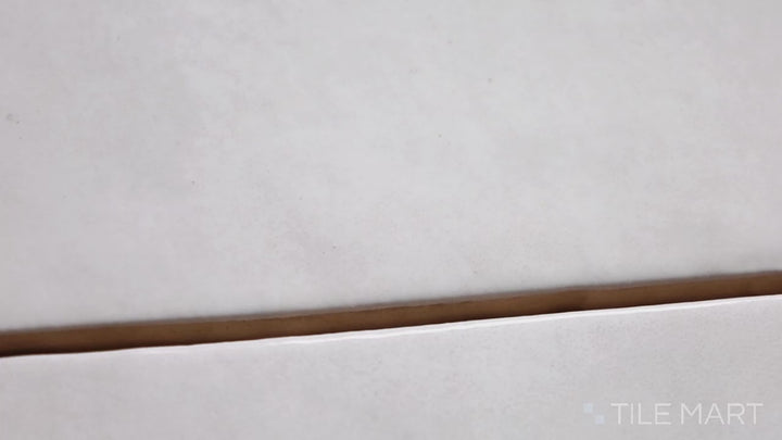 Video featuring Zenia Moon 2.5X9 Matte Glazed Porcelain. A subtle gray matte tile with a soft, moonlit finish, ideal for sleek and minimalist interiors.