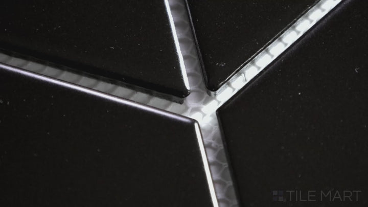 Video showcasing Shapes Black Chevron Glossy Porcelain Mosaic. A sleek black porcelain mosaic with a glossy chevron pattern, creating a bold and dynamic visual effect.