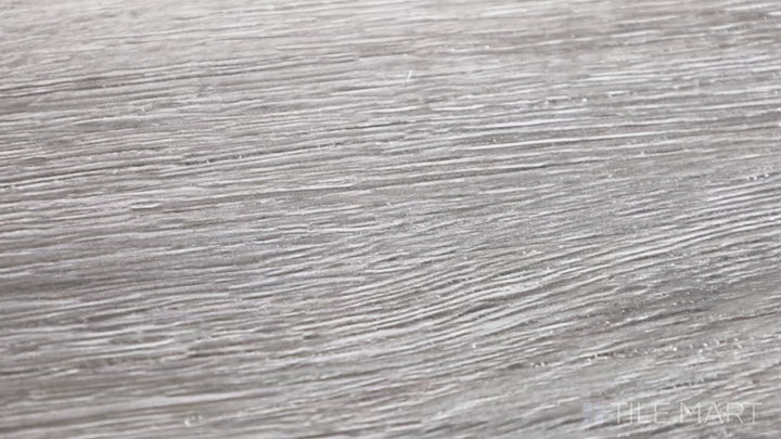 Video highlighting Cyrus Draven 7X48 Low Gloss Luxury Plank Vinyl. A deep gray-brown luxury plank with a sophisticated wood grain pattern, perfect for upscale interiors.