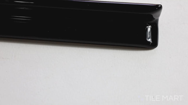 Video showcasing Sanitary Cove Base Black 1x6 Glossy Ceramic Inside Corner. A bold black glossy ceramic inside corner tile, providing a modern and structured design.