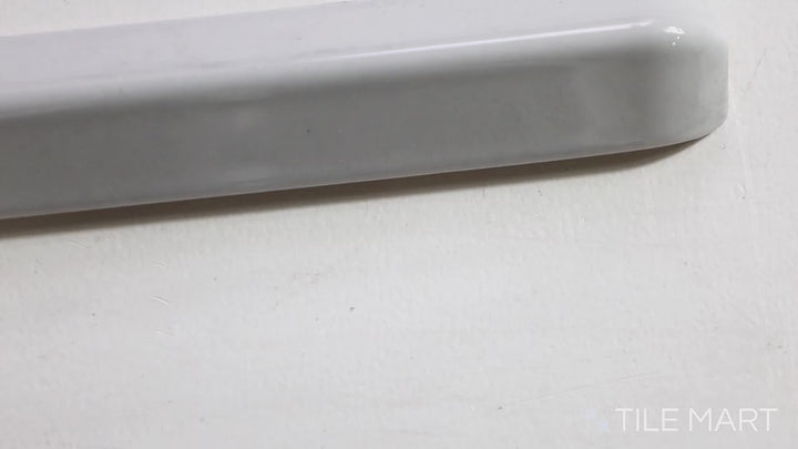 Video of Sanitary Cove Base Gray 1x6 Glossy Ceramic Inside Corner. A soft gray glossy ceramic inside corner tile, ensuring smooth and precise transitions.