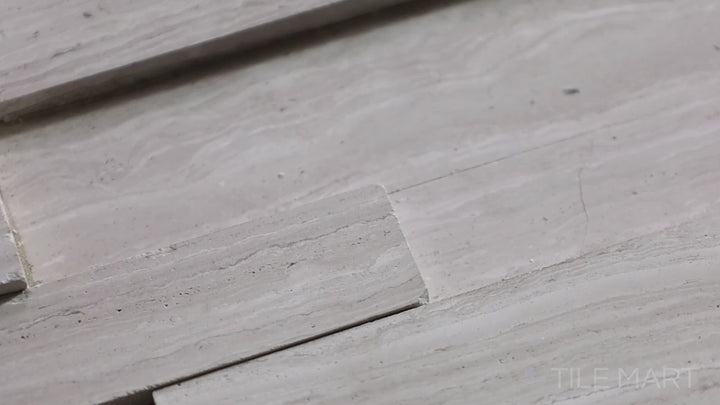Video featuring Modern Ledgestone White Wood 6x24 Porcelain. A white wood-look porcelain tile with a ledgestone texture, offering a rustic yet modern feel.