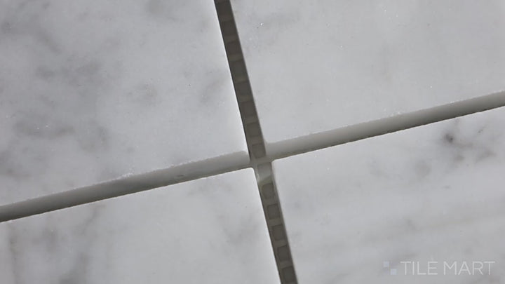 Video showcasing Sto-Re Carrara 2.25" Square Polished Marble Mosaic. Classic Carrara marble mosaic with a polished surface, arranged in a 2.25" square pattern for elegant depth.