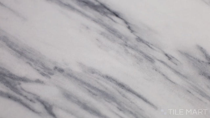 Video of Exotic Stone Cosmopolitan Statuario Fantastico 24x48 Polished Porcelain. A luxurious white porcelain tile with bold veining and a glossy finish, mimicking high-end Statuario marble.