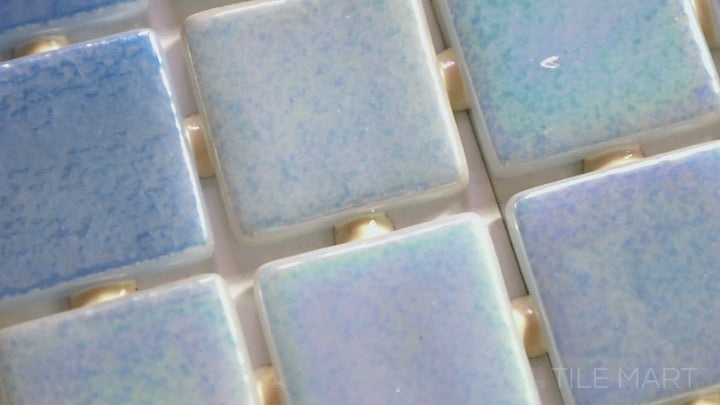 Video featuring Opalescent Celeste Azul 1-inch Square Glossy Glass Mosaic. A light blue opalescent glass mosaic with a glossy finish, bringing a serene and luminous aesthetic.