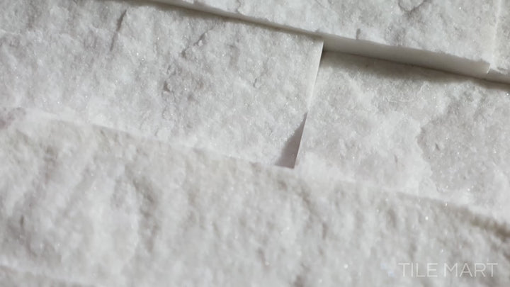 Video showcasing Rockmount Cosmic White 6X24 Stacked Stone Panel Splitface Marble. A crisp white marble panel with textured splitface details, creating a refined yet natural aesthetic.