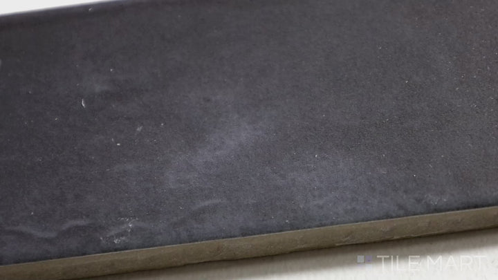 Video featuring Soco Black 2X6 Matte Porcelain Tile. A deep black tile with a sophisticated matte finish, perfect for industrial and modern aesthetics.