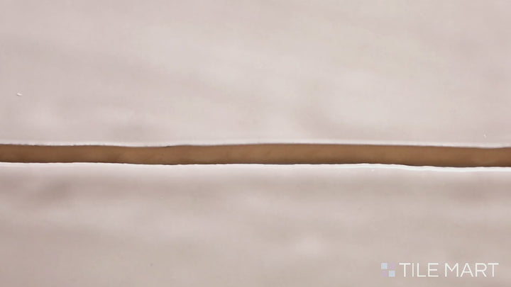 Video highlighting Marin Coastal Cliff 2.5X10 Gloss Glazed Ceramic. A neutral-toned glossy tile with a sleek surface, ideal for sophisticated coastal aesthetics.