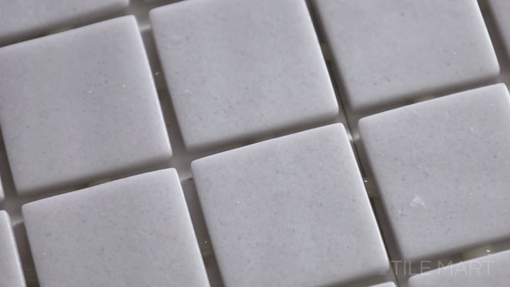 Video highlighting Natureglass Malla Smooth Grey 1-inch Square Matte Glass Mosaic. A soft grey matte glass mosaic with a polished yet understated finish, adding subtle depth.