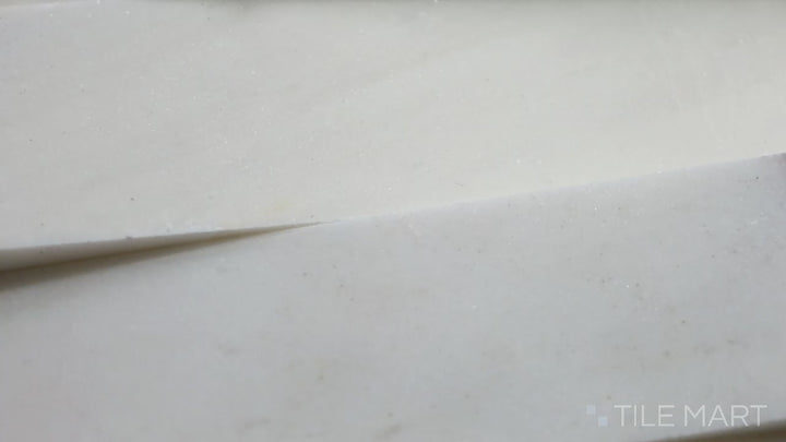 Video of Rockmount Cosmic White 6X24 Stacked Stone Panel Honed Marble. A bright white honed marble panel that enhances light reflection for a modern, airy feel.