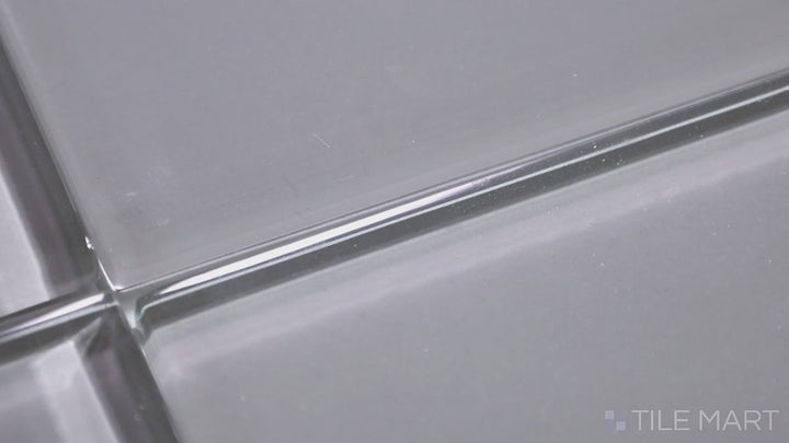 Video featuring Glass Pastel Grey 3x12 Glossy. A subtle pastel grey glass tile with a high-gloss sheen, creating a refined and contemporary aesthetic with a clean, polished look.