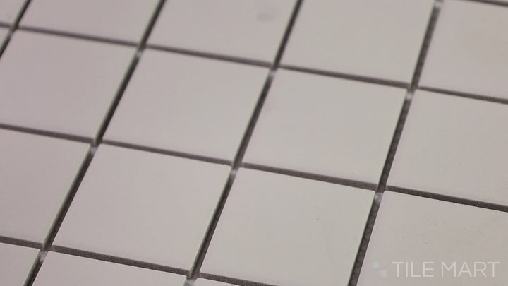 Video showcasing Marin Pebble Gray 2" Square Matte Glazed Porcelain Mosaic. A neutral gray square tile with a contemporary matte look, perfect for minimalist designs.