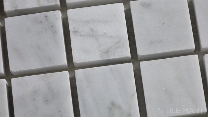 Video of Sto-Re Carrara 1-1/8" Square Polished Marble Mosaic. Classic Carrara marble mosaic with a polished surface, composed of 1-1/8" square tiles for a traditional yet elegant design.