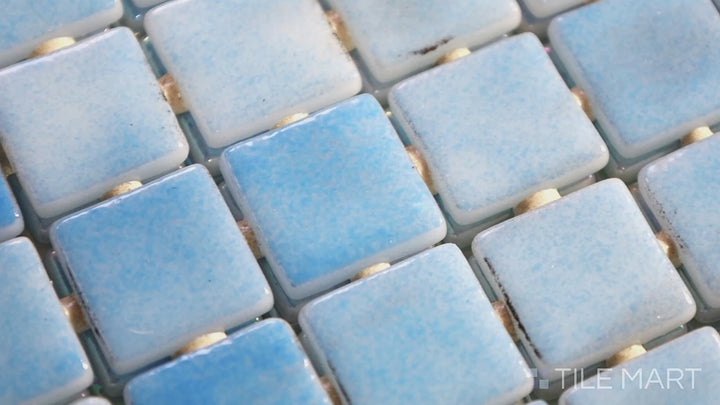 Video featuring Opalescent Mix Azul 1-inch Square Glossy Glass Mosaic. A blend of blue opalescent glass mosaics with a glossy finish, creating a dynamic and stylish effect.
