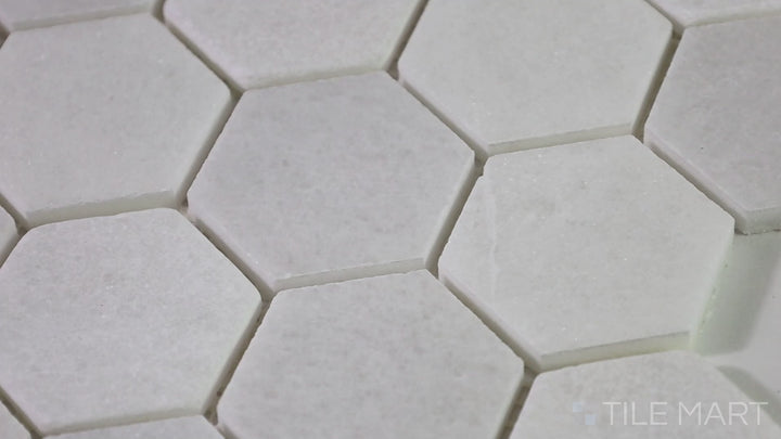 Video of The Finish Line Pale Beige 2" Hexagon Polished Marble Mosaic. A warm beige hexagonal marble tile with a polished finish, perfect for contemporary and traditional spaces.