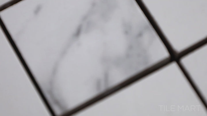 Video of Select White Carrara 2" Square Polished Porcelain Mosaic. A polished porcelain mosaic with a white Carrara-inspired look, offering elegance and precision.