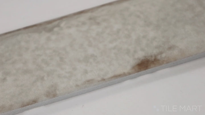 Video featuring Organic Clay Sand 2X10 Glossy Ceramic. A warm, sandy-hued tile with a luminous finish, creating an inviting and airy atmosphere.