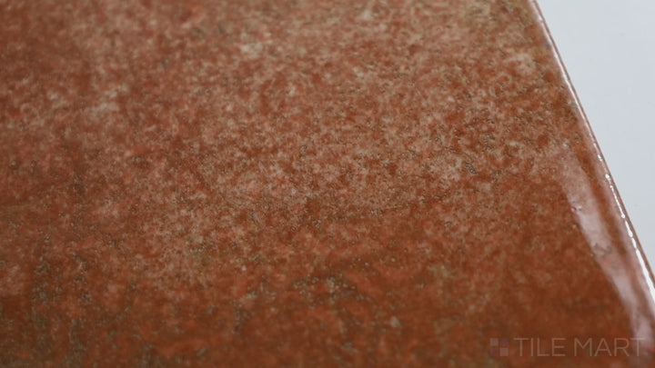 Video of Intermix Earth 6X6 Glossy Ceramic. A neutral-toned tile with a reflective glossy sheen, ideal for adding warmth and style to your living spaces.