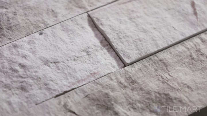 Video highlighting Rockmount White Oak 6X24 Stacked Stone Panel Splitface Marble. A classic white marble stacked stone panel with natural veining and texture.