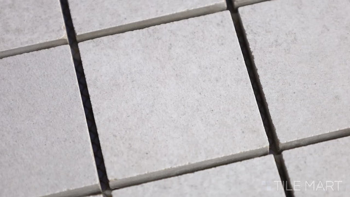 Video highlighting Concrete Gray 2-inch Square Matte Porcelain Mosaic. A neutral gray porcelain mosaic with a smooth matte finish, offering a sleek and minimalistic appeal.