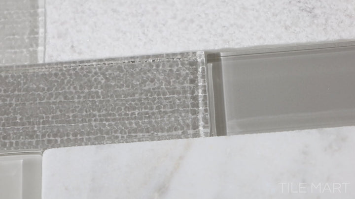 Video featuring Simplystick Mosaix Daphne White And Glass Blend Honed And Polished Marble, Limestone Mosaic. A unique combination of honed and polished marble with glass for added dimension.