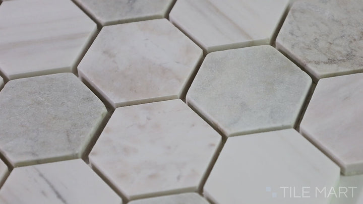 Video of The Finish Line Pale Beige 2" Hexagon Polished Marble Mosaic. A warm beige hexagonal marble tile with a polished finish, perfect for contemporary and traditional spaces.