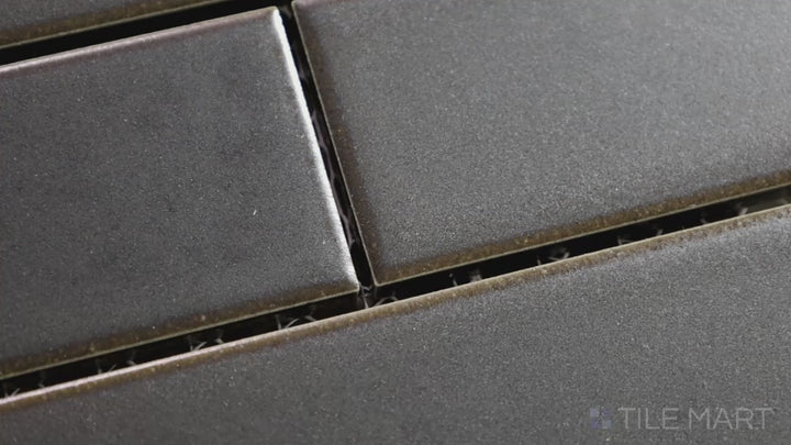 Video featuring Zenia Orbit Rectangle Matte Glazed Porcelain Mosaic. A deep charcoal matte mosaic with a refined texture, enhancing modern and bold designs.