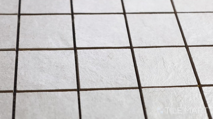 Video of Ash White 2-inch Square Matte Porcelain Mosaic. A bright white porcelain mosaic tile with a smooth matte surface, offering a fresh and clean aesthetic with a refined layout.