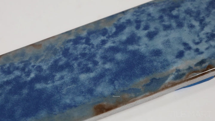 Video of Organic Clay Oceanic 2X10 Glossy Ceramic. A deep, ocean-inspired hue with a reflective surface, adding a bold yet elegant touch to interiors.