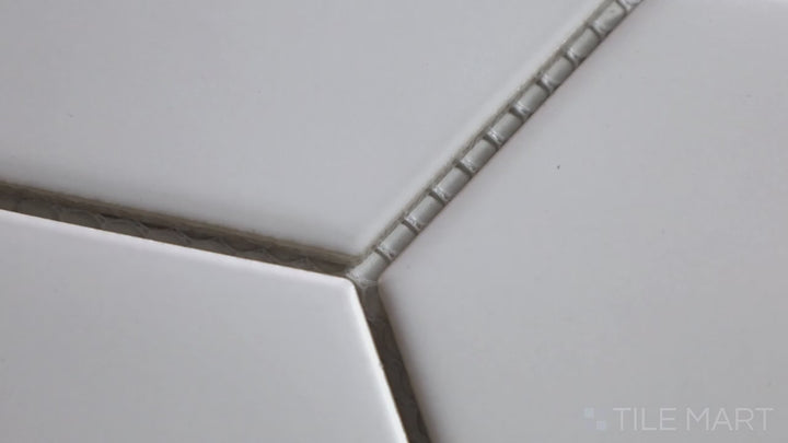 Video showcasing Porcelain Glazed Mosaics White 4-inch Hexagon Matte. A luminous white matte porcelain hexagonal mosaic, adding elegance with a clean geometric pattern.